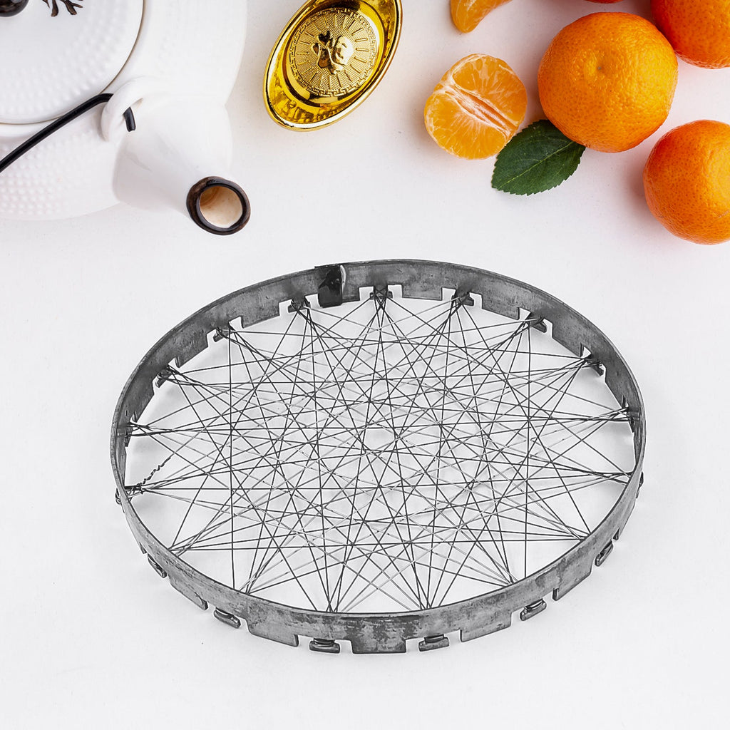 Indo Glow Chota Tandoor Grill jalli placed on a gas stove burner, ready for use.