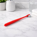 Kids toothbrush with soft bristles and ergonomic handle for gentle cleaning