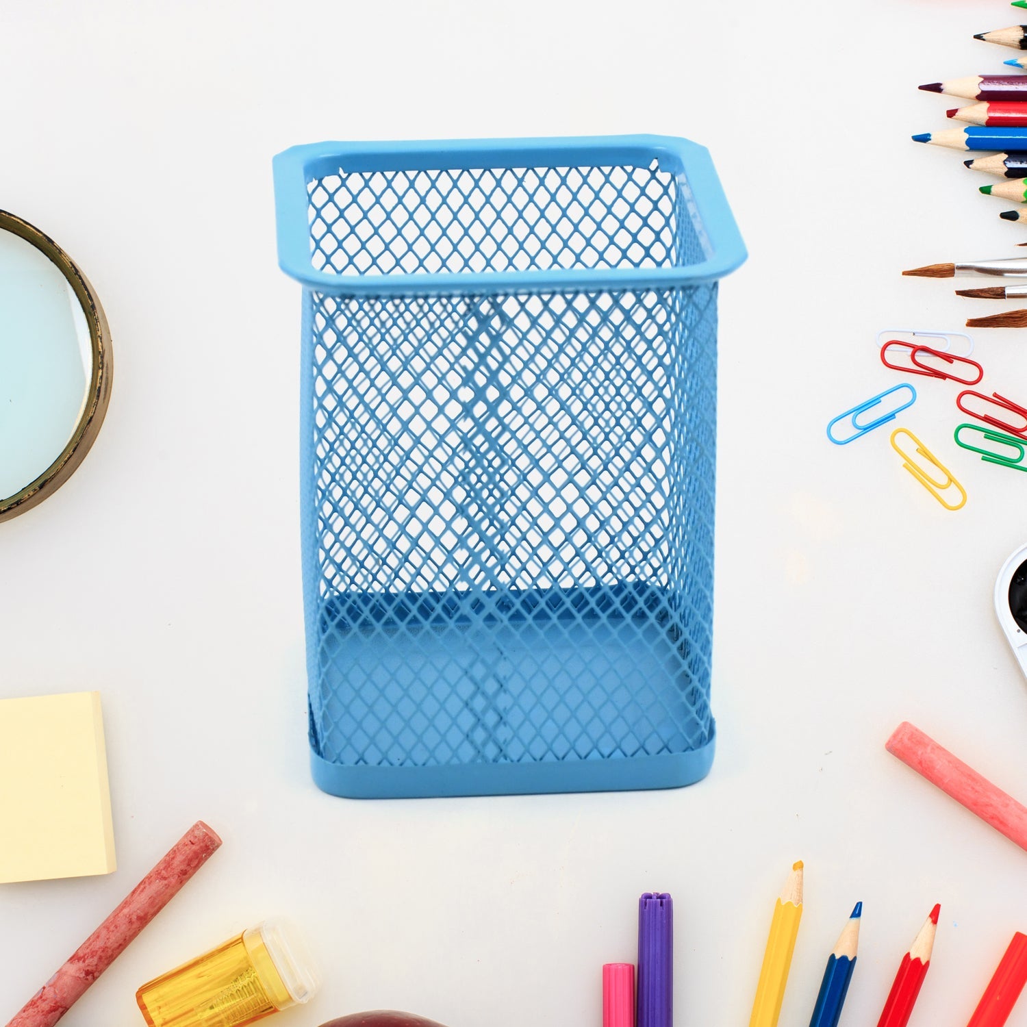 Sleek black metal mesh pen holder for a tidy office desk.