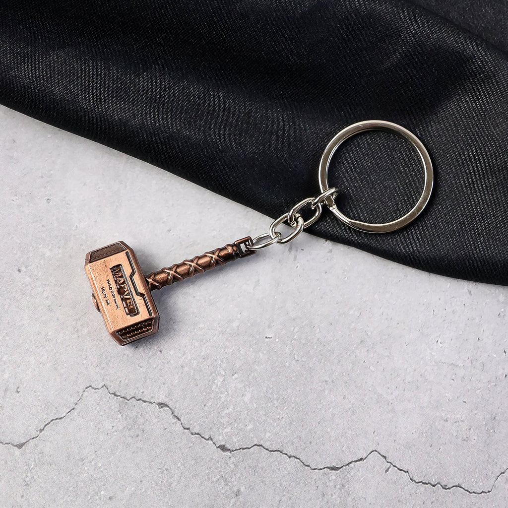Metal Hammer Keychain with antique bronze finish on neutral background