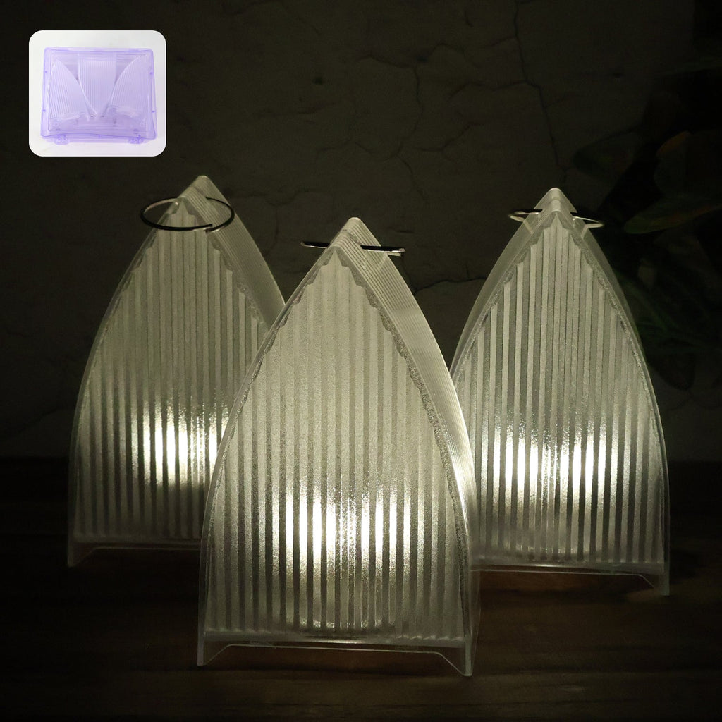 Set of three flameless LED lantern lights with frosted ribbed design emitting warm glow