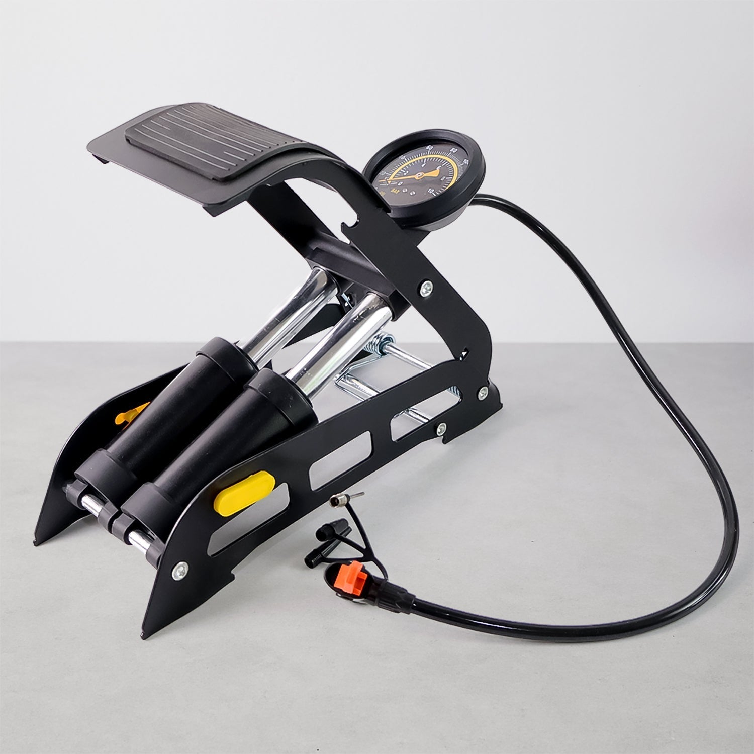 Portable dual-cylinder foot air pump for quick tire inflation on cars and bikes.