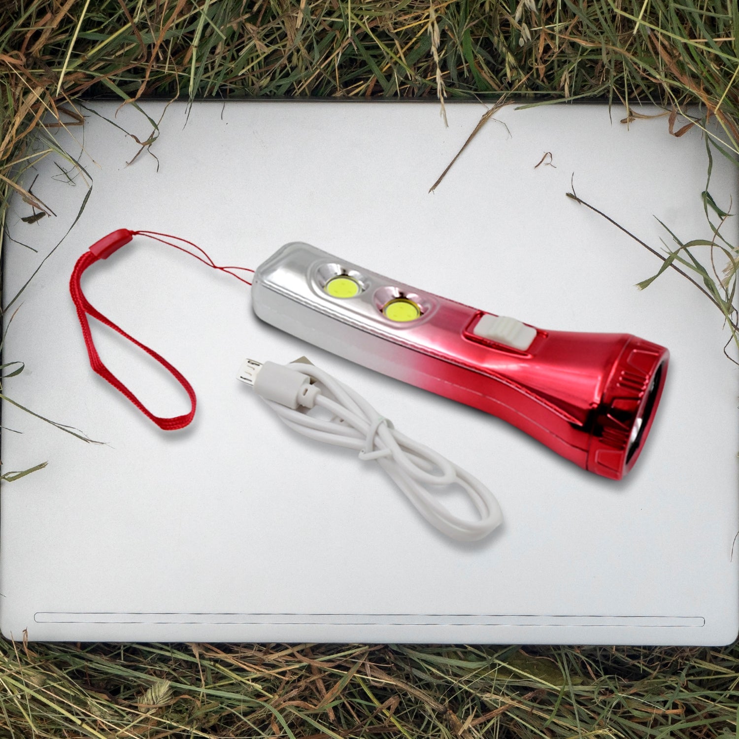 Portable LED torchlight resting on a flat surface, ready for use.