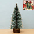 Mini artificial Christmas tree with realistic snow effect on branches and wooden base