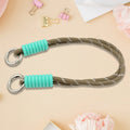 A phone with a vibrant multi-colored phone wrist strap attached, held securely.