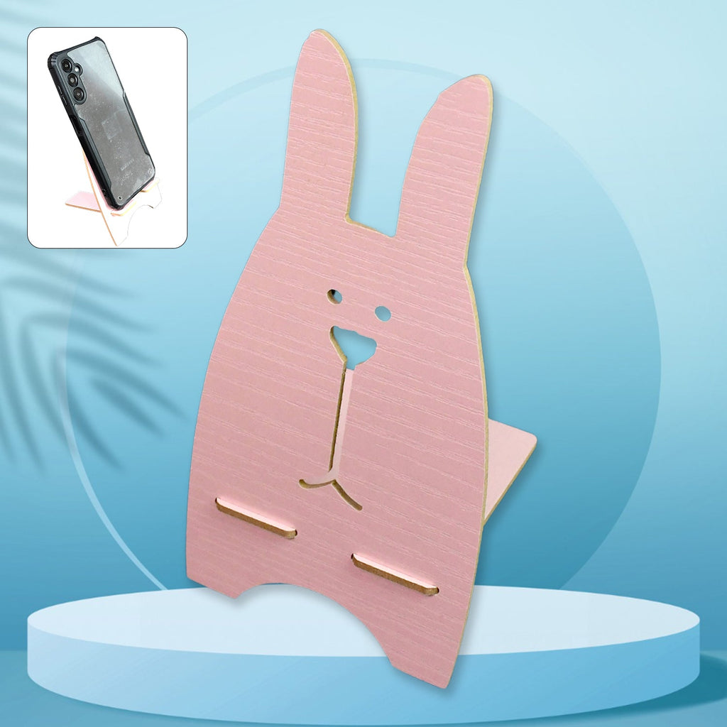 Front view of the wooden rabbit mobile stand holding a smartphone on a desk.