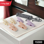 Strong plastic clips securely holding clothes on drying rope