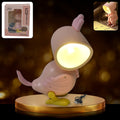 Magnetic Parrot Night Lamp glowing on a bedside table.