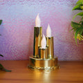 Golden LED flameless candle lamp with triple candle design glowing softly