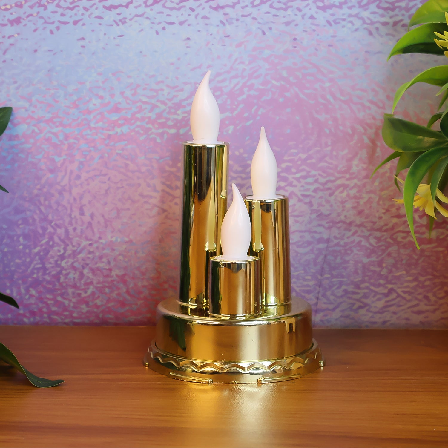 Golden LED flameless candle lamp with triple candle design glowing softly