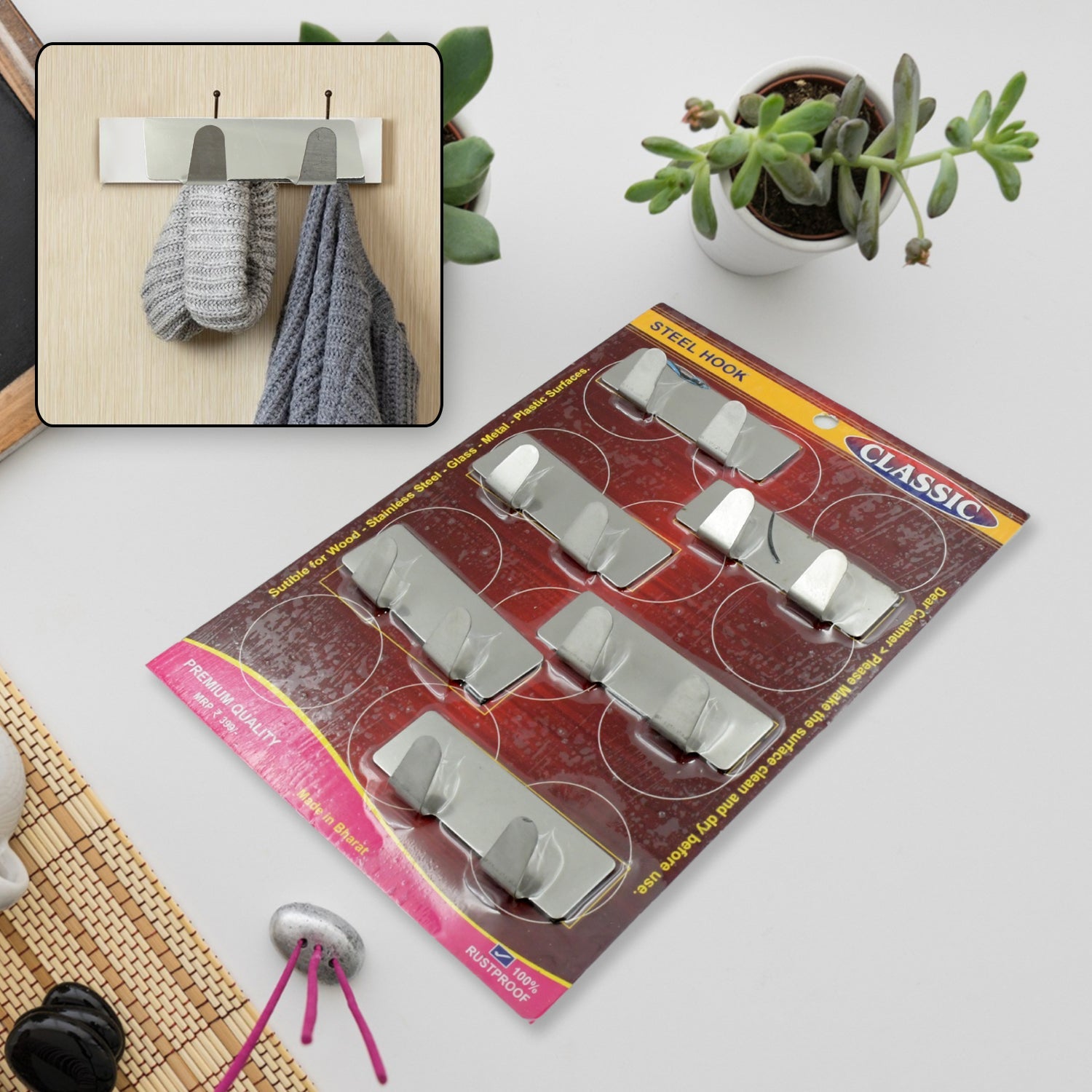 Durable stainless steel self-adhesive wall hook for kitchen organisation.