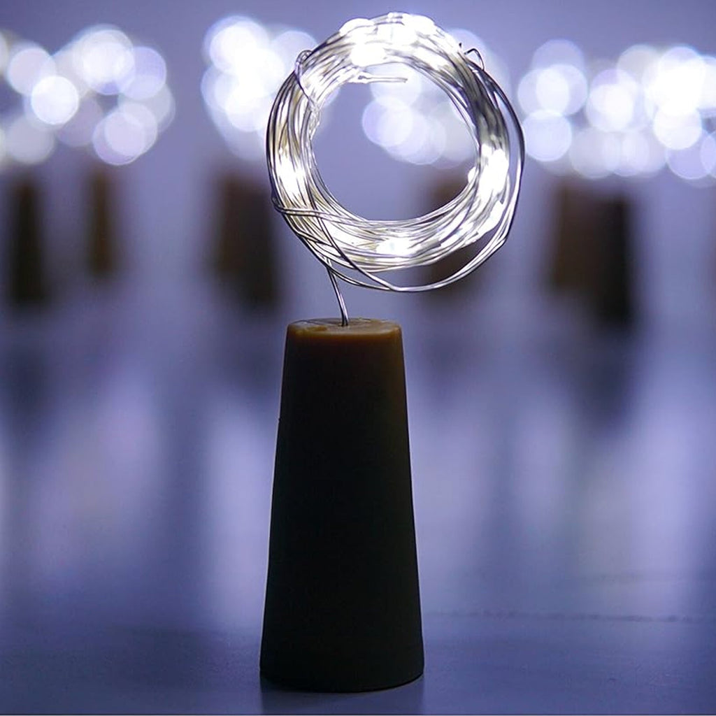 An illuminated wine bottle cork string light creating a warm ambiance on a wooden surface.