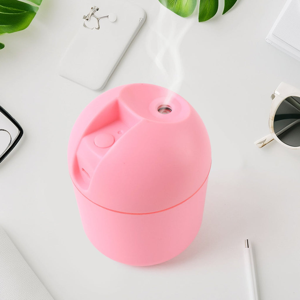 USB Mini Air Humidifier on desk emitting cool mist with soft LED light