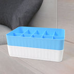 Two 10-grid drawer organiser boxes neatly storing socks and underwear inside a drawer.