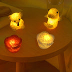 A single LED Crystal Night Light illuminating a dark room with a warm glow.