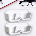 Organivo Sunglass Wall Organizer mounted on a white wall, showcasing easy adhesive installation.