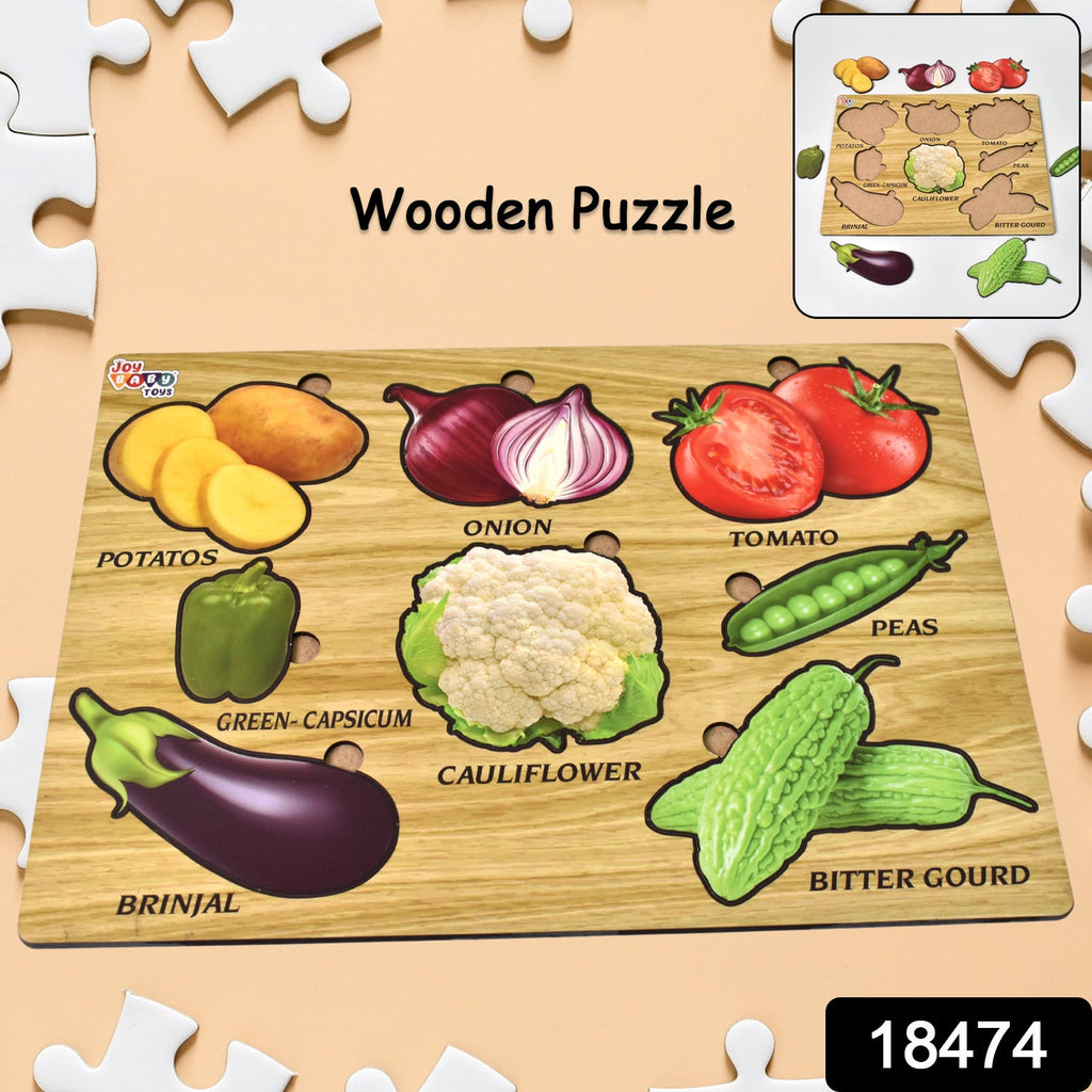 Toddler's hands playing with an educational wooden vegetable puzzle on a light surface.