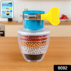 A Faucet Water Filter attached to a kitchen tap, showing clear water flowing into a glass.