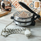 Electric roti maker with stainless steel heating plate on kitchen countertop