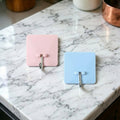 Self-adhesive wall utility hook with square base mounted on wall