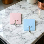 Self-adhesive wall utility hook with square base mounted on wall