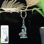 Front view of silver Shivling keychain featuring intricate snake motif
