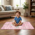 A happy baby playing on a reversible Baby Play Mat with an animal theme.