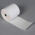 Thermal label roll for barcode printing showing crisp print and self-adhesive backing