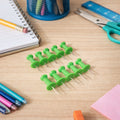 Close-up of green push pins with strong metal pins for notice boards