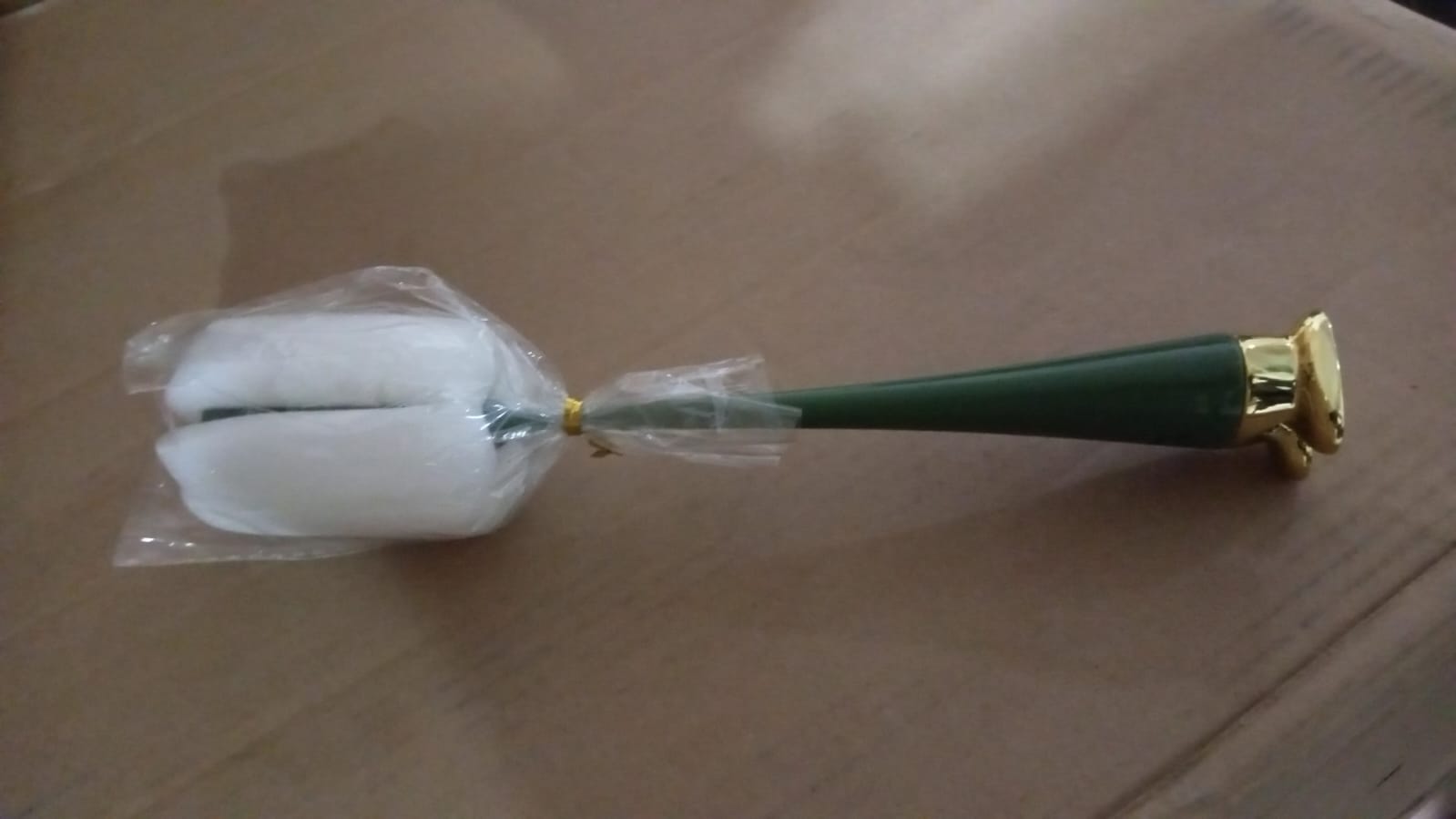 Ergonomic long handle bottle brush demonstrating its reach into a narrow-necked bottle.