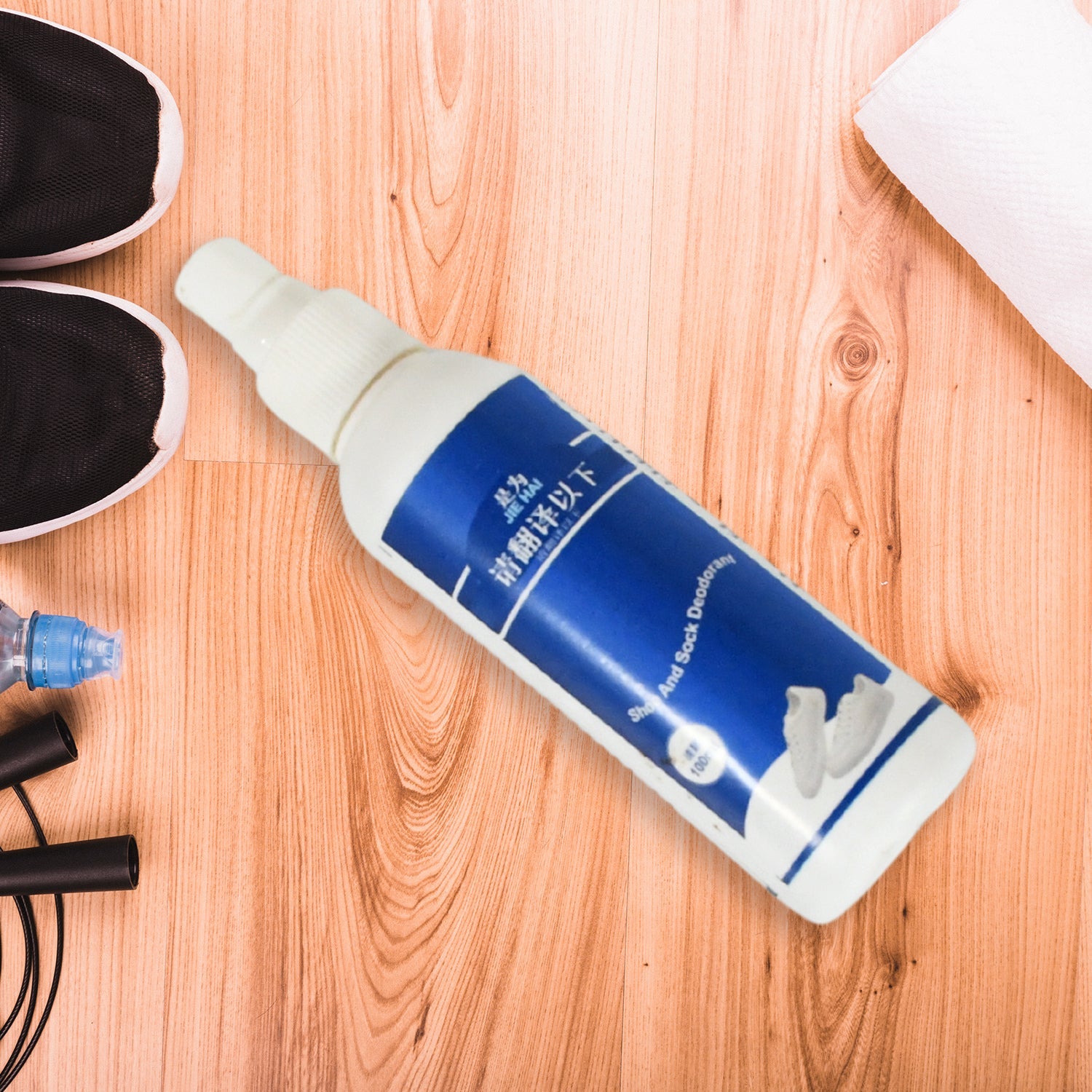 Velvet Wheels shoe spray bottle next to various footwear for freshness.
