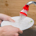 Compact plastic 360-Degree Shower Head attached to a tap, showing its flexible design.