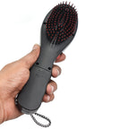 Black electric hair massager comb with bristles for scalp stimulation.