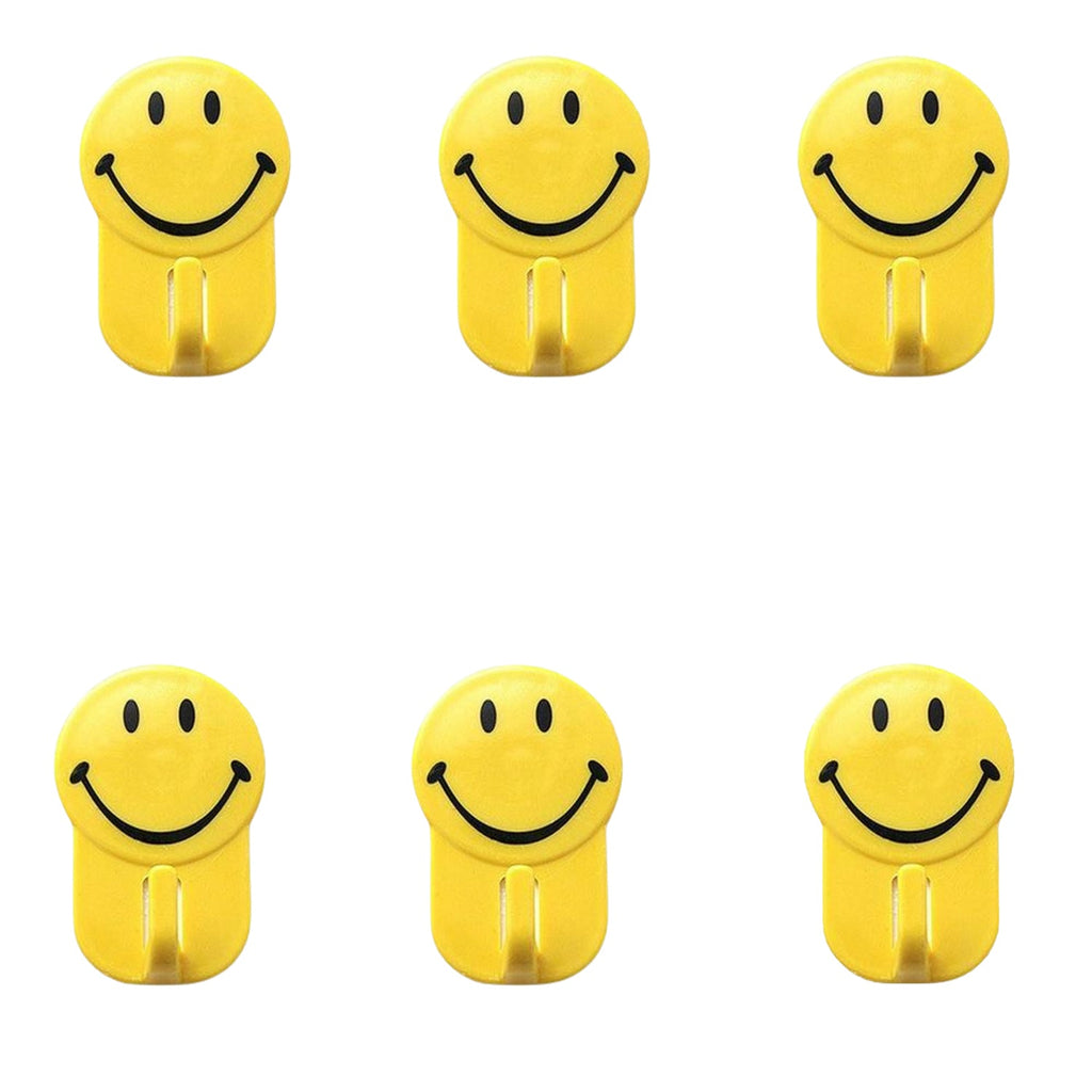 Close-up of a plastic smiley face hook demonstrating its self-adhesive backing.