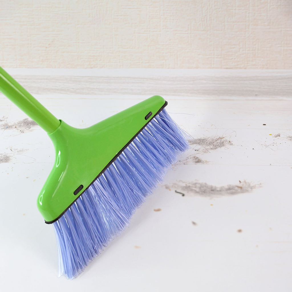 Compact foldable dustpan attached to broom for easy carrying and storage
