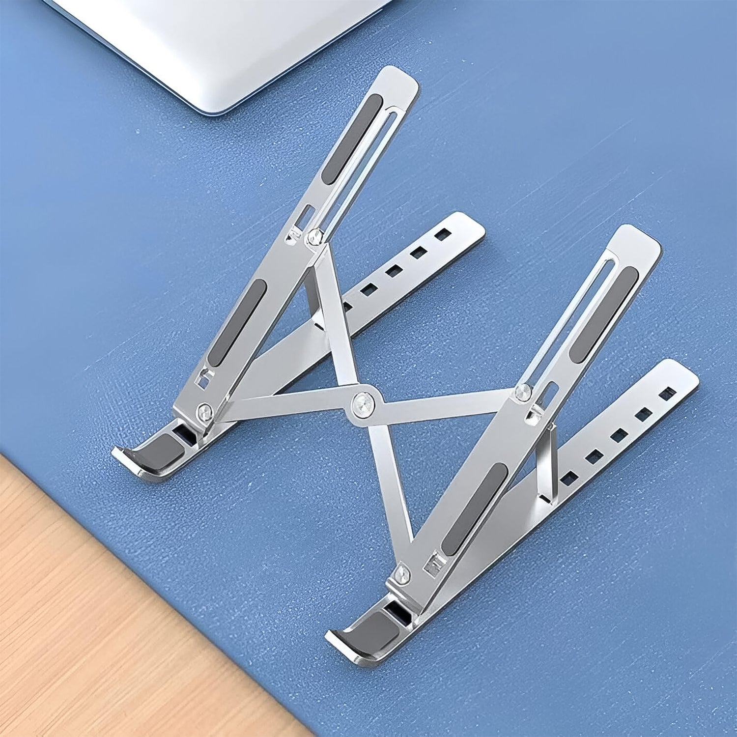 Foldable laptop stand elevating a laptop to improve ventilation and comfort