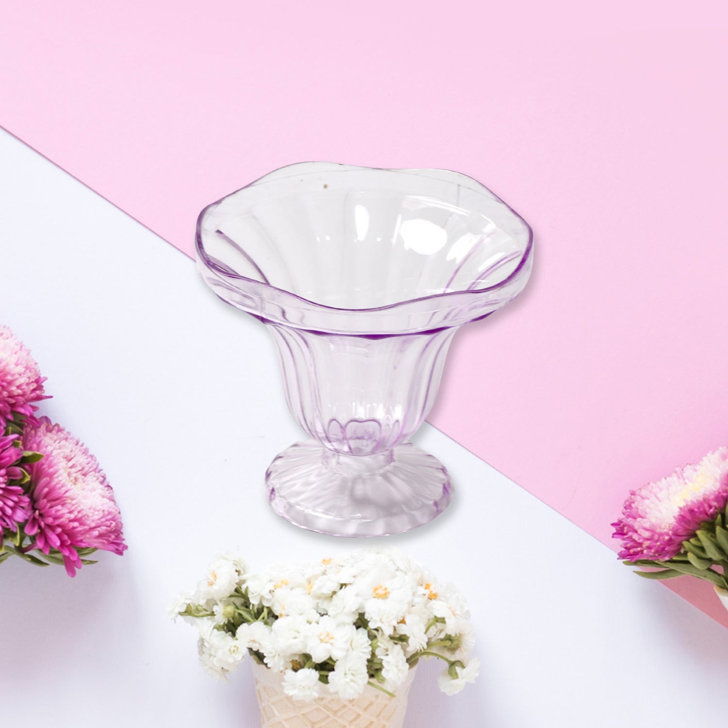 A pair of plastic dessert cups filled with colorful layered parfaits.