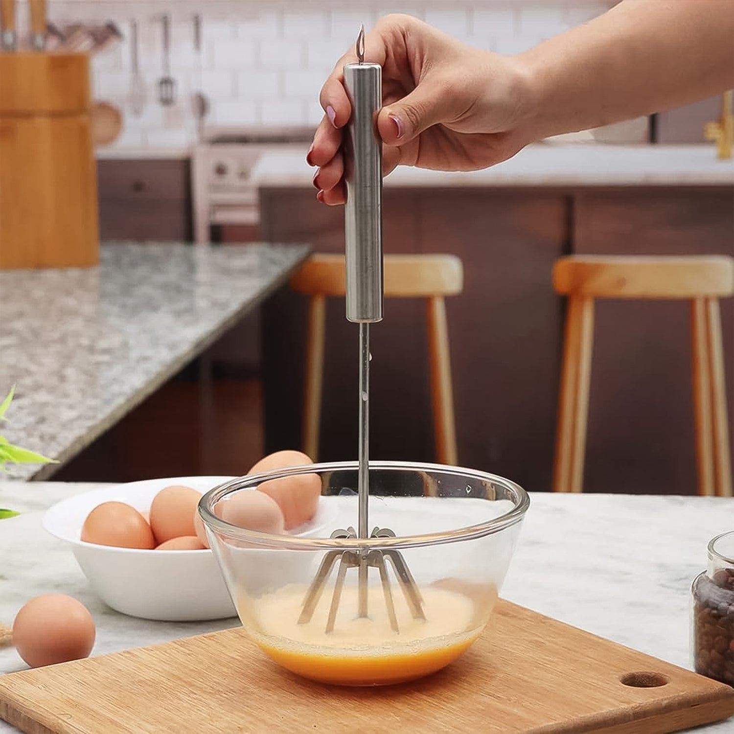 Detailed view of the sleek design of the manual stainless steel hand blender.