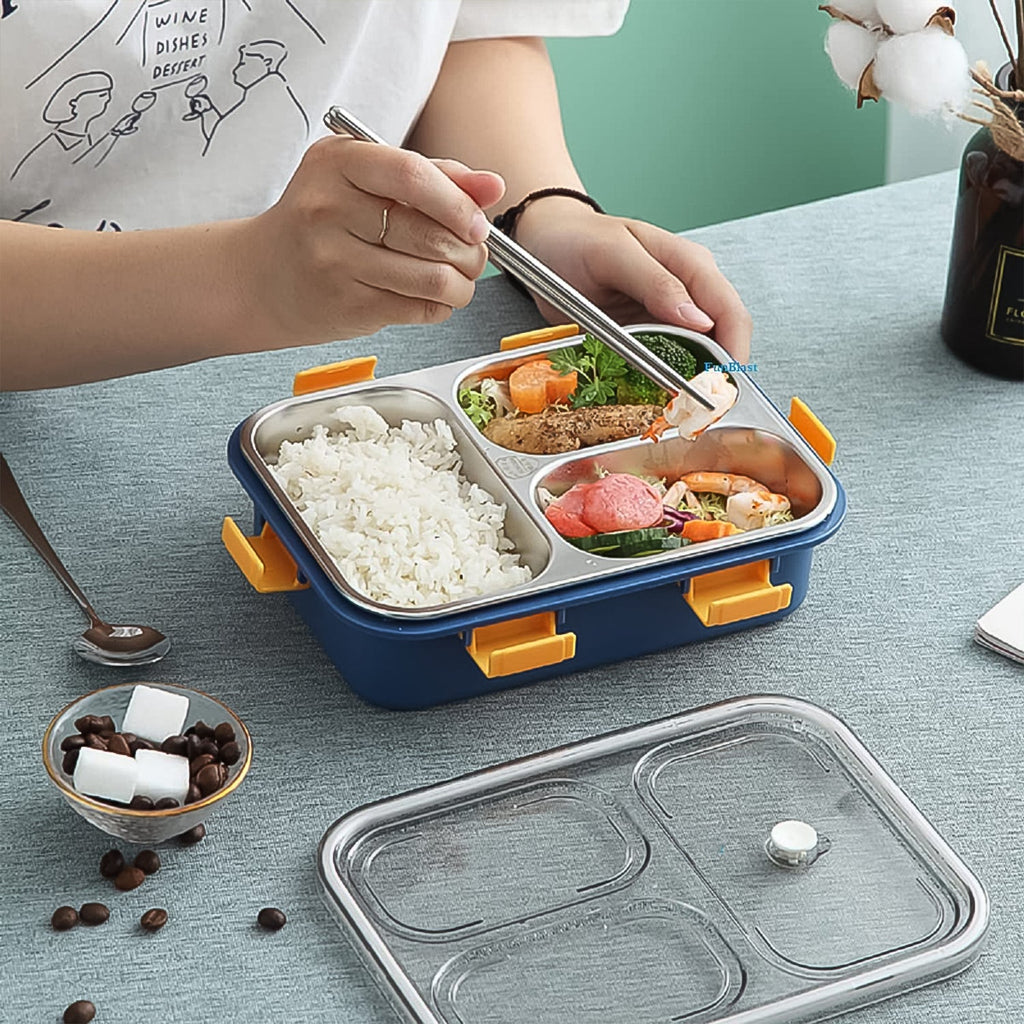 Stainless steel lunch box displayed with its transparent lid and three food compartments.