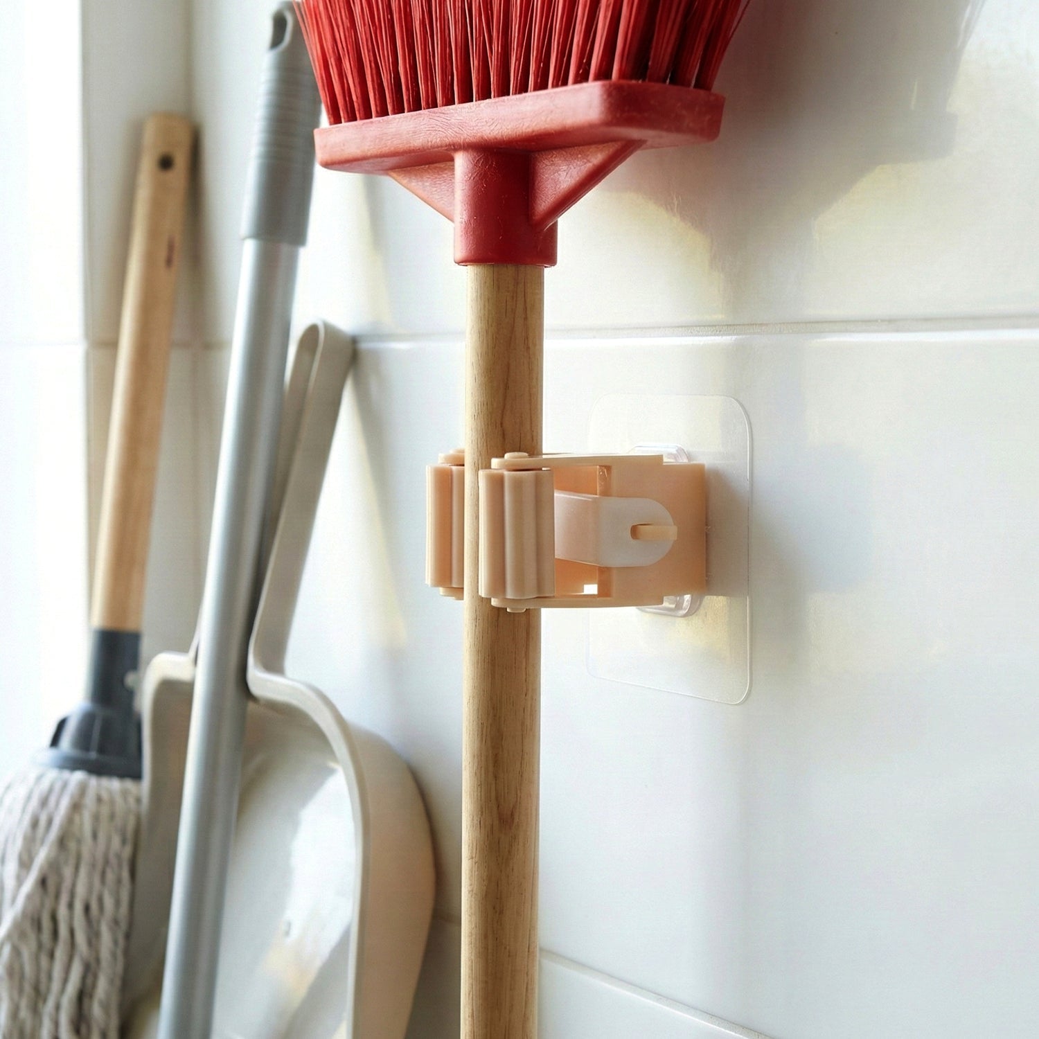 Self-adhesive stick holder clip mounted firmly on wall