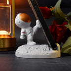 Group of diverse 3D Astronaut Phone Holders in various poses and colours.