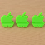 Assorted color apple-shaped mobile phone stands displayed together