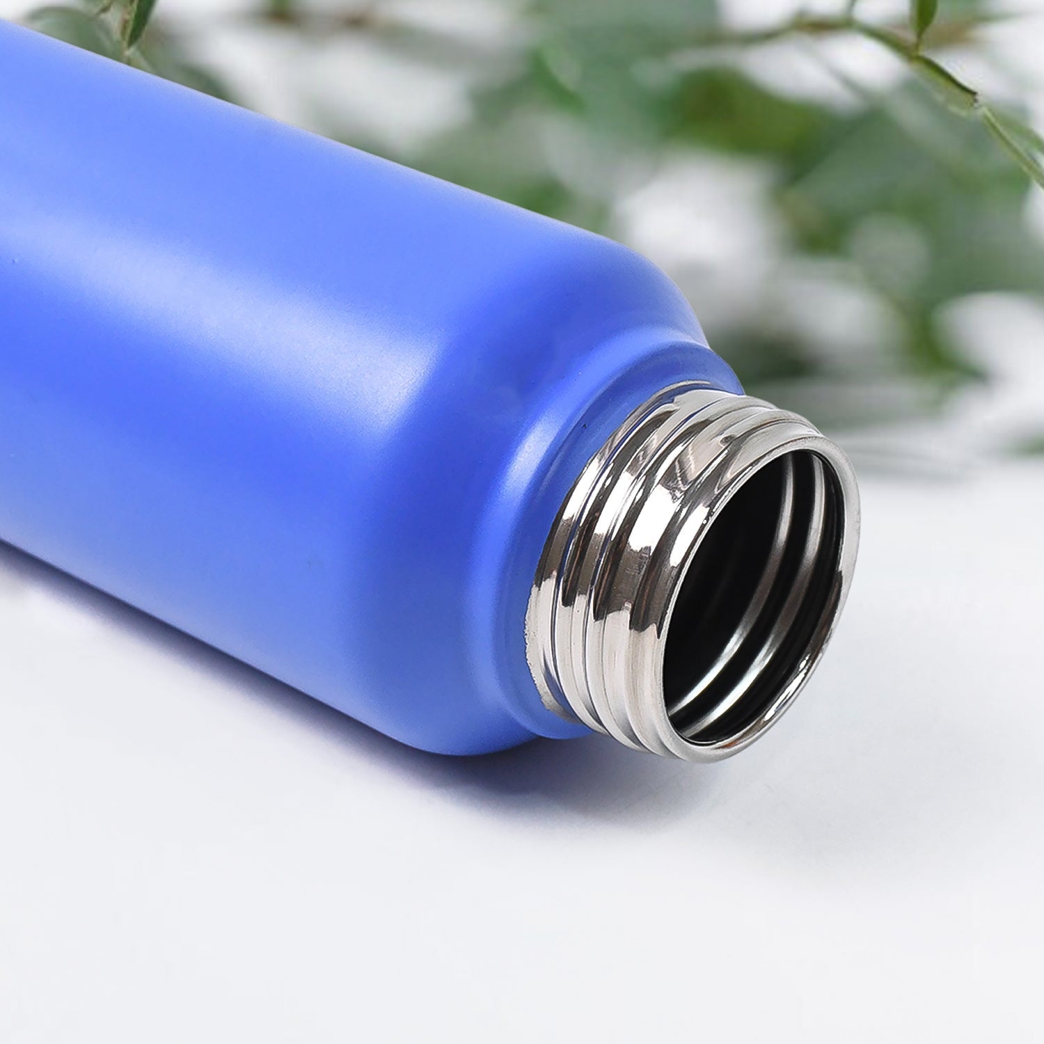 Side view of stainless steel water bottle with strap handle for easy portability
