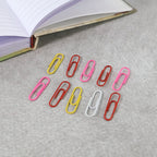 Mixed colour steel paper clips with protective vinyl coating to prevent paper damage and rust.