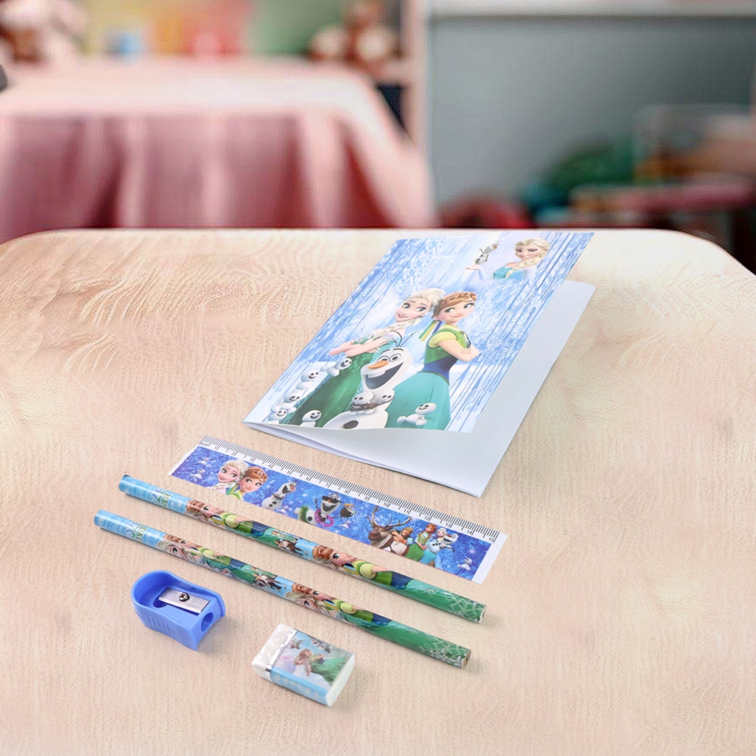 Close-up of a vibrant wooden pencil featuring a playful cartoon design from the stationery kit.