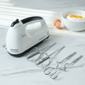 Electric hand mixer set with stainless steel beaters and dough hooks on countertop