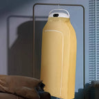 Mini portable dryer efficiently drying clothes on hangers.