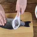 A Quickslice Fish Scale Scraper with an ergonomic handle for comfortable grip.