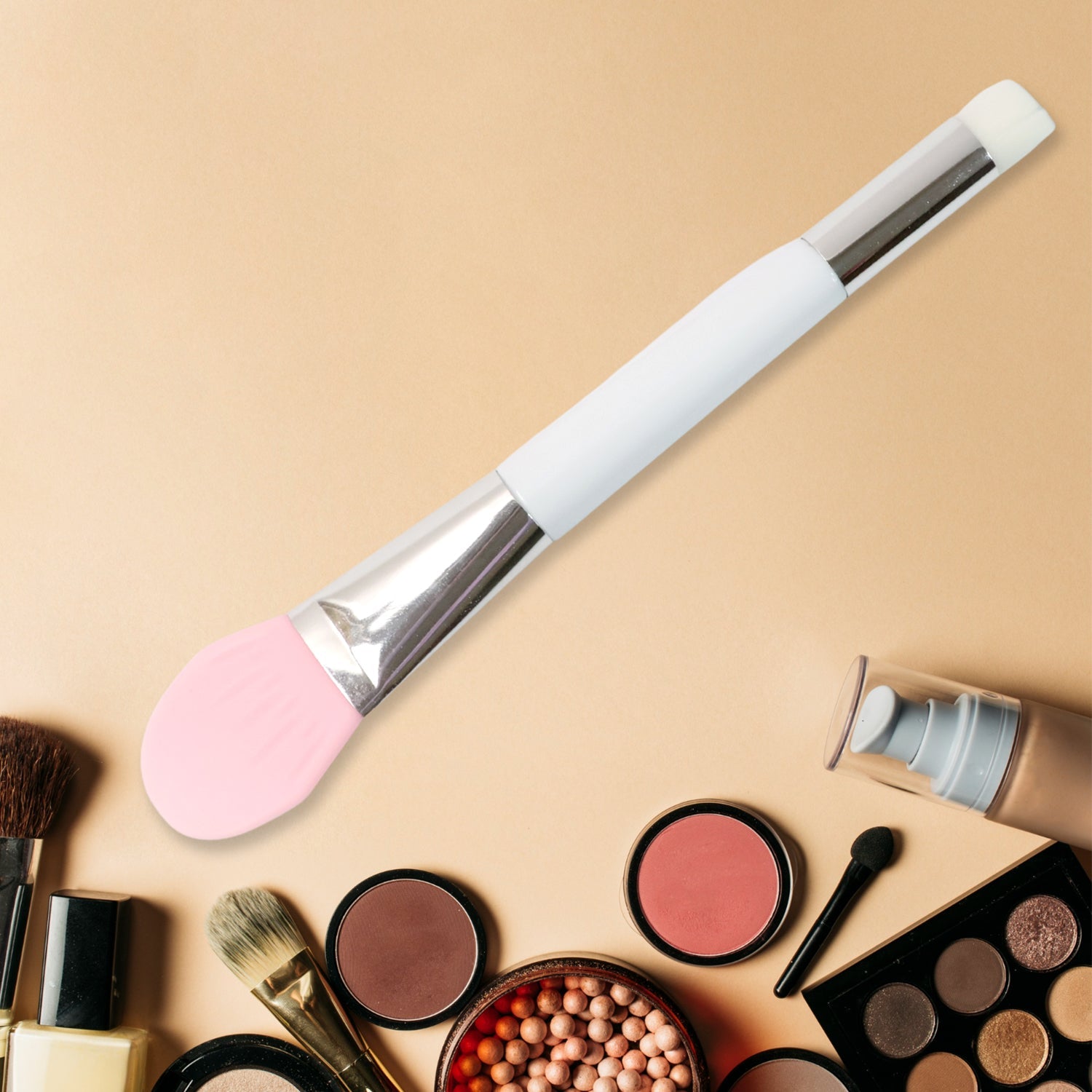 Hand holding silicone applicator brush for facial mask application