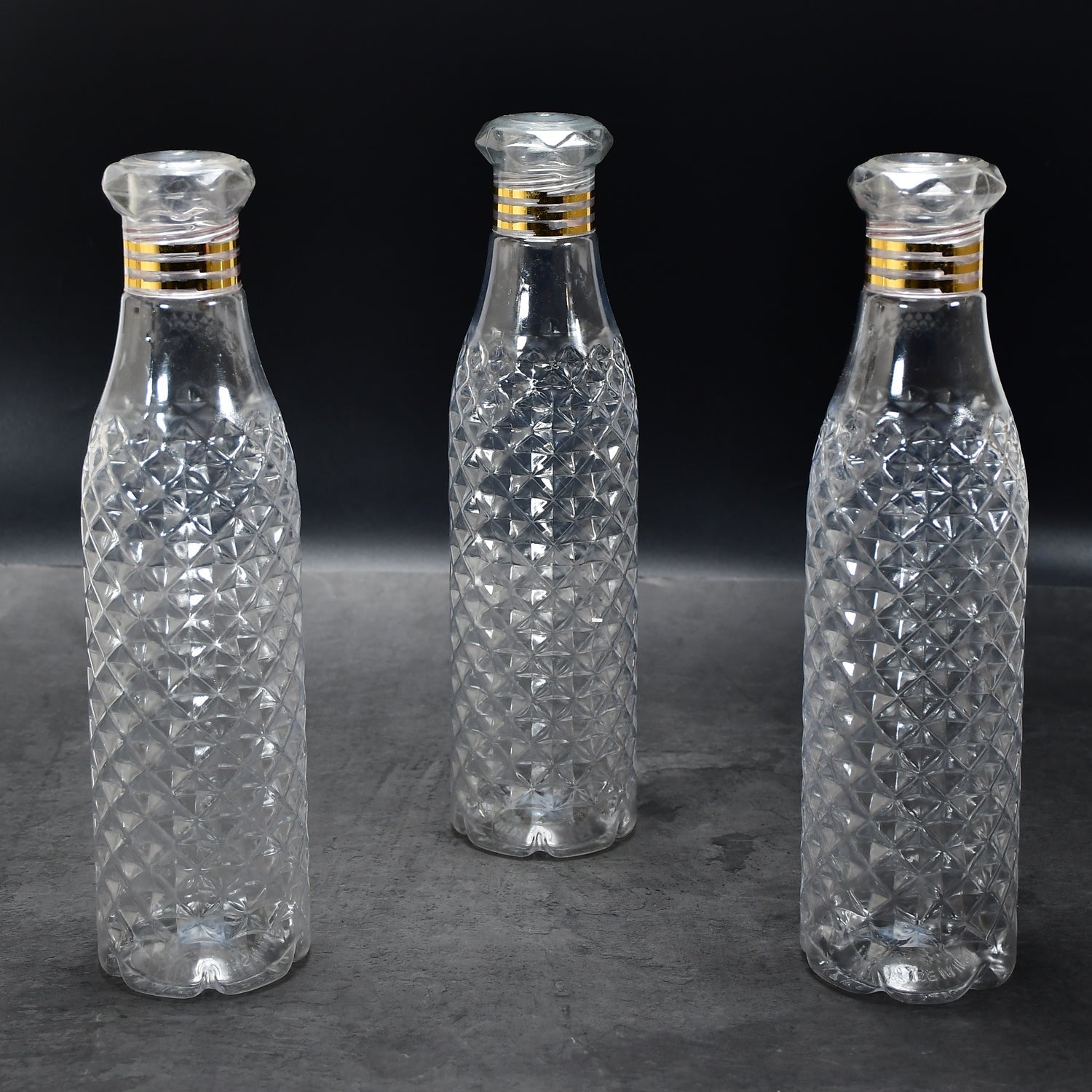 Close-up of the translucent diamond cut water bottles, highlighting their durable plastic.